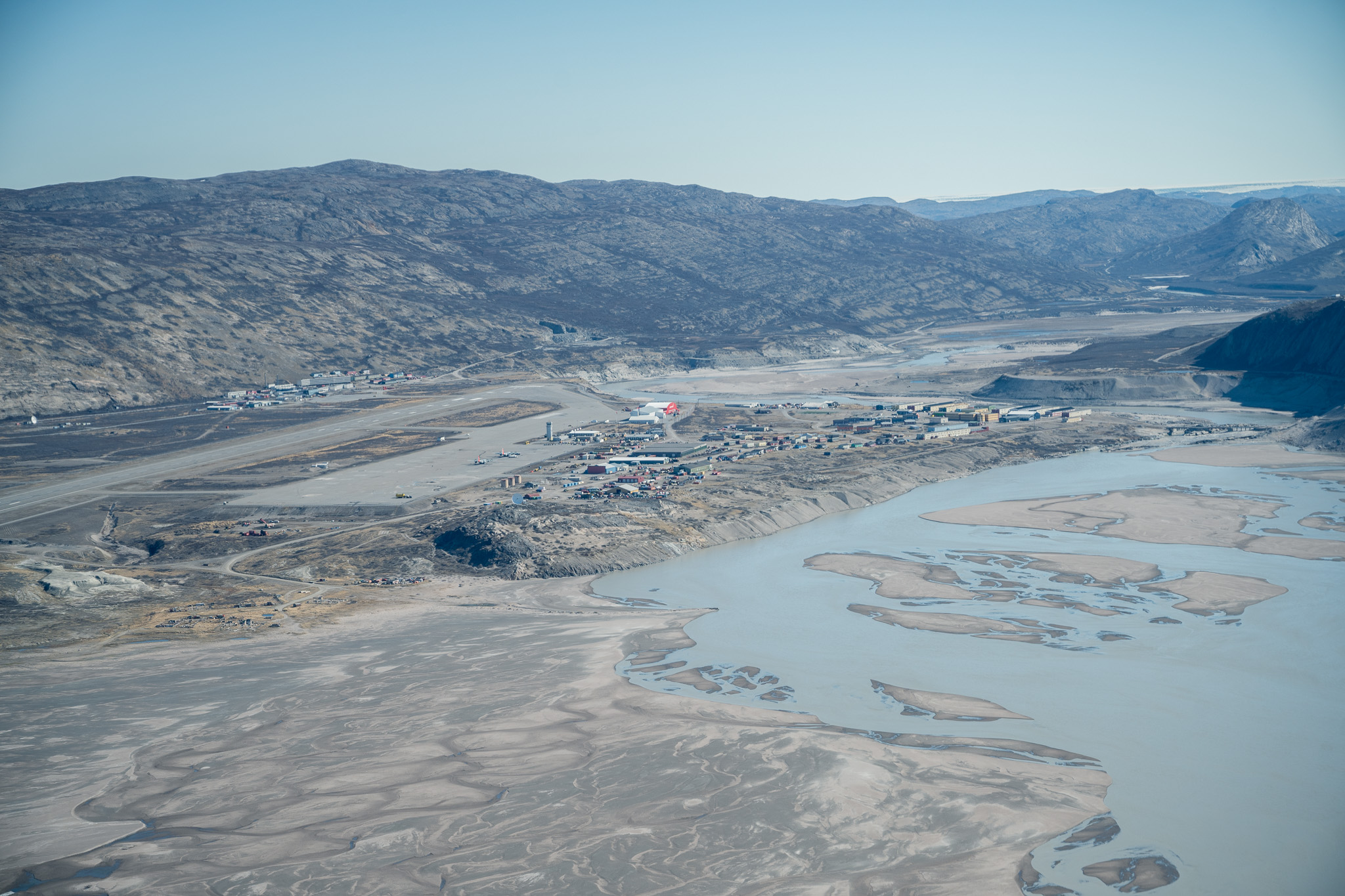 A Greenland airport between mountains and a glacial river