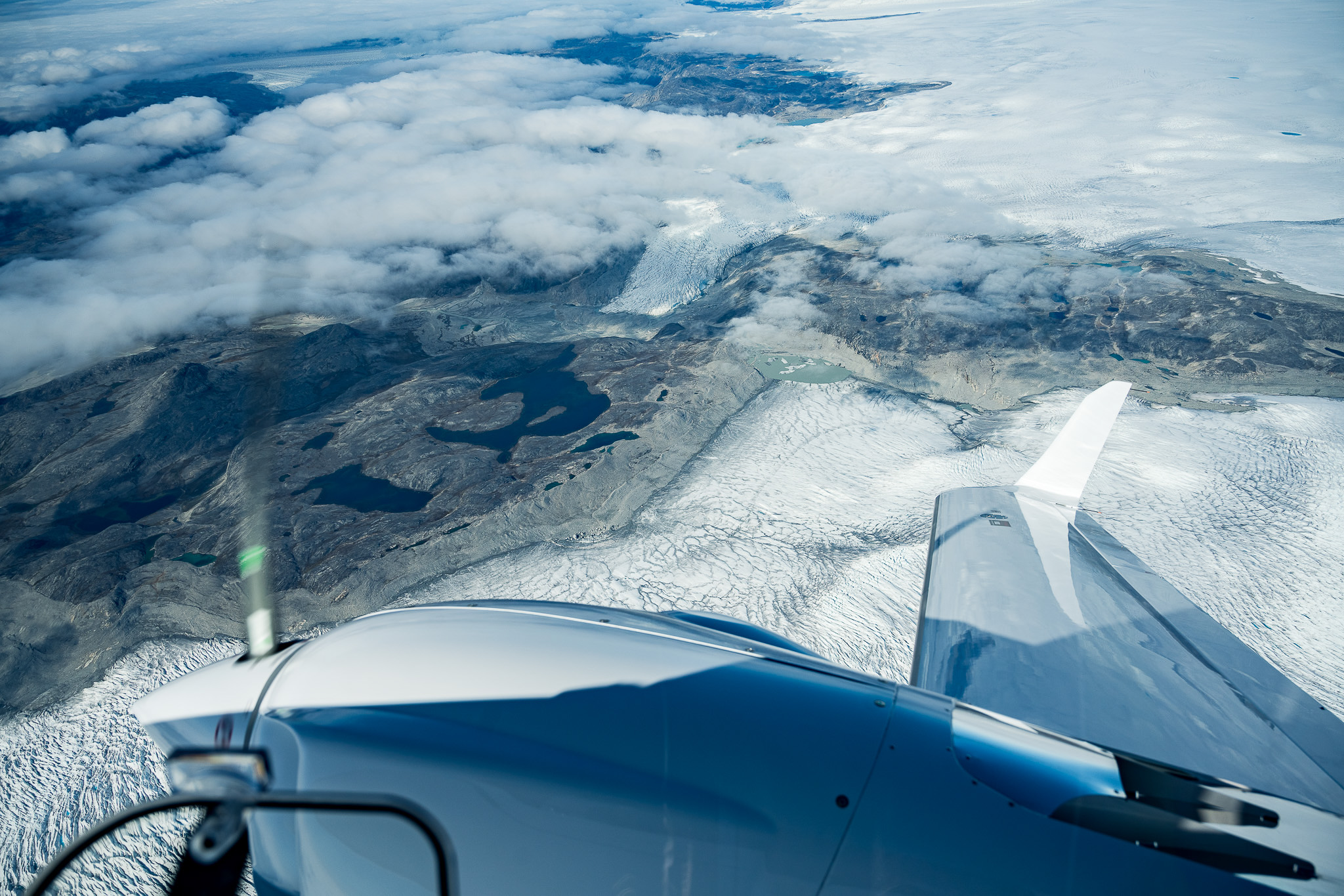 Greenland glaciers seen beyond the Diamond aircraft flight deck and wing