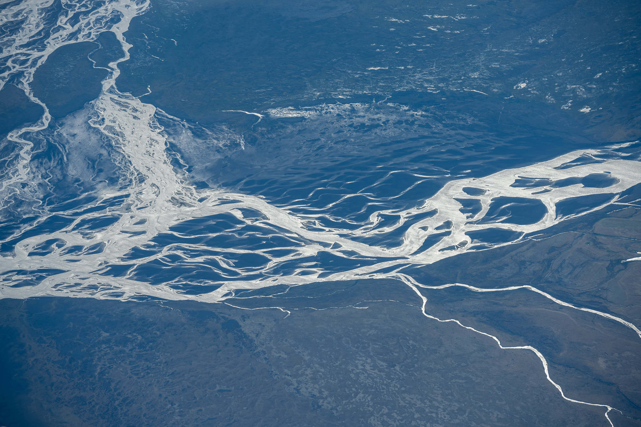 Braided glacial rivers crossing the Greenland landscape
